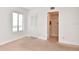 Bedroom with neutral carpeting, large window, and en-suite bathroom at 954 Courtyard Ln # 11, Orlando, FL 32825