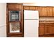Bright kitchen with wood cabinets, built-in oven, and refrigerator at 954 Courtyard Ln # 11, Orlando, FL 32825