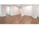 Spacious room with wood-look floors, leading to a bathroom and a closet at 1124 Munster St, Orlando, FL 32803