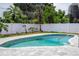 Relaxing kidney-shaped pool with a gray stone deck at 1124 Munster St, Orlando, FL 32803