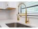 Modern kitchen sink with gold faucet and marble countertop at 1124 Munster St, Orlando, FL 32803