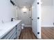 Modern bathroom with gray vanity, quartz countertop, and walk-in shower at 1124 Munster St, Orlando, FL 32803