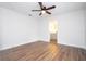 Bright bedroom with wood-look floors, ceiling fan and ensuite bathroom at 1124 Munster St, Orlando, FL 32803