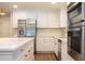 Modern kitchen with white cabinets, stainless steel appliances and an island at 1124 Munster St, Orlando, FL 32803