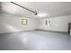 Garage with painted floor, door to outside, and ample space at 1124 Munster St, Orlando, FL 32803