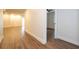 Long hallway with light walls and wood-look floors at 1124 Munster St, Orlando, FL 32803