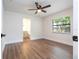 Bedroom with wood-look floors, ceiling fan, and ensuite bathroom access at 1124 Munster St, Orlando, FL 32803