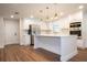 Modern kitchen with white cabinets, stainless steel appliances, and a large island at 1124 Munster St, Orlando, FL 32803
