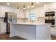 Modern kitchen with white cabinets, stainless steel appliances, and a large island at 1124 Munster St, Orlando, FL 32803