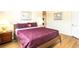 Bedroom with king-size bed, wood nightstands, and wood floors at 441 Montara Dr, Davenport, FL 33897