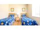 Bedroom with two twin beds and space-themed bedding at 441 Montara Dr, Davenport, FL 33897