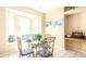 Charming breakfast nook with glass table, built-in window seat, and ocean-themed art at 441 Montara Dr, Davenport, FL 33897