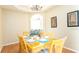 Bright dining room with wood table and chairs, hardwood floors, and decorative wall art at 441 Montara Dr, Davenport, FL 33897