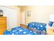 Bedroom with two twin beds and space-themed bedding at 441 Montara Dr, Davenport, FL 33897