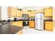 Kitchen features wood cabinets, stainless steel appliances, and dark countertops at 441 Montara Dr, Davenport, FL 33897