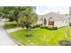 Single story home with a manicured lawn and mature trees at 441 Montara Dr, Davenport, FL 33897