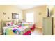 Bedroom with two twin beds, Trolls-themed bedding, and wood floors at 441 Montara Dr, Davenport, FL 33897