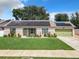 Brick ranch home with solar panels and landscaped lawn at 1092 Providence Blvd, Deltona, FL 32725