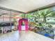 Enclosed patio with pet cages and a playhouse at 1092 Providence Blvd, Deltona, FL 32725