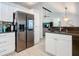 Open concept kitchen with stainless steel refrigerator and view into living room at 1092 Providence Blvd, Deltona, FL 32725