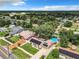 Aerial view of a neighborhood with houses, trees, and a distant lake at 1092 Providence Blvd, Deltona, FL 32725