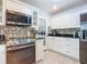 Bright kitchen with white cabinets, stainless steel appliances, and mosaic backsplash at 1092 Providence Blvd, Deltona, FL 32725