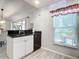 White kitchen cabinets, granite countertops, and a breakfast bar at 1092 Providence Blvd, Deltona, FL 32725