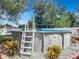 Inviting above-ground pool with a ladder, surrounded by landscaping at 1092 Providence Blvd, Deltona, FL 32725