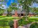 Brick house with a gated entrance and manicured lawn at 2820 Jacana Ct, Longwood, FL 32779