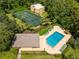Community pool, tennis court, and clubhouse with lush landscaping at 4806 S Semoran Blvd # 201, Orlando, FL 32822