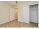 Bright bedroom with wood-look floors, a large closet, and an additional room at 4806 S Semoran Blvd # 201, Orlando, FL 32822