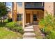 Ground level condo entrance with steps and landscaping at 4806 S Semoran Blvd # 201, Orlando, FL 32822