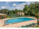 Refreshing community pool with plenty of lounge chairs at 4806 S Semoran Blvd # 201, Orlando, FL 32822