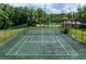 Well-maintained tennis court with surrounding greenery at 4806 S Semoran Blvd # 201, Orlando, FL 32822