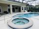 Inviting pool and spa area with screened enclosure at 5509 Meadow Hill Loop, Lady Lake, FL 32159