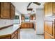 Kitchen with wood cabinets, breakfast bar, and view to dining area at 1005 Crescent Pkwy, Deland, FL 32724