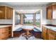 Kitchen with wood cabinets, corner window seat, and wood-style flooring at 1005 Crescent Pkwy, Deland, FL 32724
