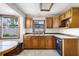 Kitchen with wood cabinets, double sink, and vinyl flooring at 1005 Crescent Pkwy, Deland, FL 32724