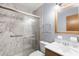 Bathroom with a shower and wood vanity at 1005 Crescent Pkwy, Deland, FL 32724