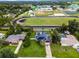 Aerial view showing house, pool, and nearby school at 1005 Crescent Pkwy, Deland, FL 32724