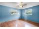 Blue bedroom with wood floors and ceiling fan at 1005 Crescent Pkwy, Deland, FL 32724
