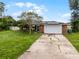 Brick house with a large front yard and a cracked driveway at 1005 Crescent Pkwy, Deland, FL 32724