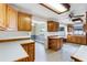Kitchen with wood cabinets, a pantry, and vinyl flooring at 1005 Crescent Pkwy, Deland, FL 32724
