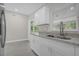 Modern kitchen with white cabinets, granite countertops, and stainless steel sink at 3133 Bon Air Dr, Orlando, FL 32818