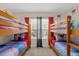 Bedroom with two wooden bunk beds, each with colorful themed bedding at 2767 Lido Key Dr, Kissimmee, FL 34747