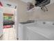 Laundry room with washer, dryer, and storage shelving at 2767 Lido Key Dr, Kissimmee, FL 34747