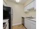 Modern kitchen with stainless steel appliances and white cabinets at 4806 S Semoran Blvd # 201, Orlando, FL 32822