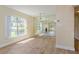 Sunlit dining room featuring a mirrored wall and hardwood floors at 4806 S Semoran Blvd # 201, Orlando, FL 32822