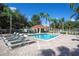 Inviting community pool with lounge chairs and a cabana at 2615 Emerald Island Blvd, Kissimmee, FL 34747