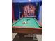 Game room with pool table and Avengers mural at 2615 Emerald Island Blvd, Kissimmee, FL 34747